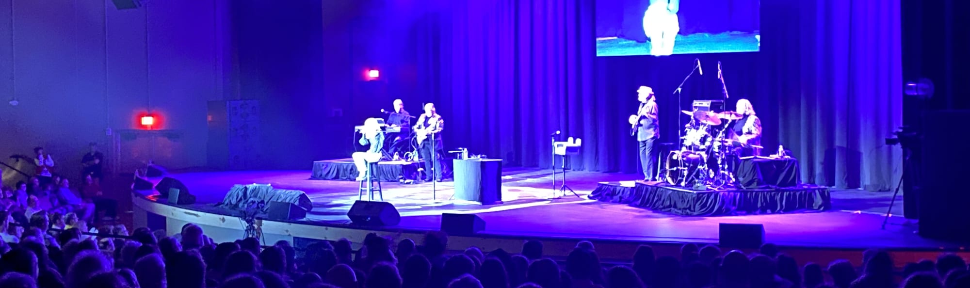 signer on stage in chair washed out by the lights Salt Lake City